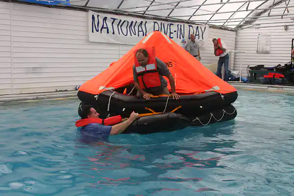 An inflated liferaft in a pool for a training and demonstration session