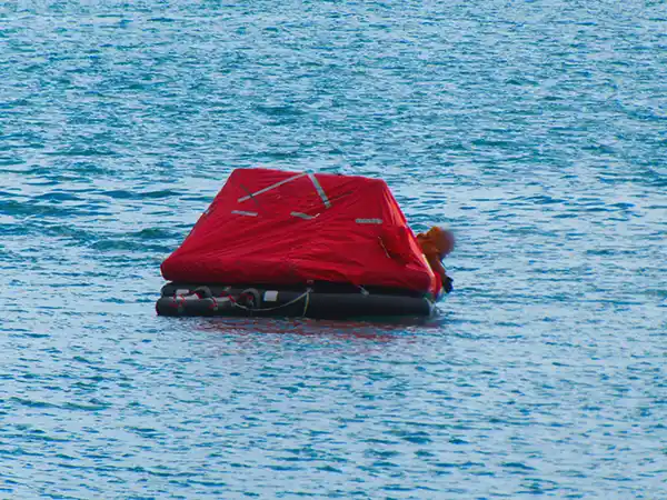 An inflated liferaft, at sea.